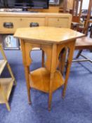 AN EARLY TWENTIETH CENTURY OAK HEXAGONAL OCCASIONAL TABLE WITH MOORESQUE ARCHES TO THE FRIEZE