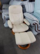A 'STRESSLESS' CREAM LEATHER RECLINING ARMCHAIR WITH MATCHING STOOL
