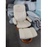 A 'STRESSLESS' CREAM LEATHER RECLINING ARMCHAIR WITH MATCHING STOOL