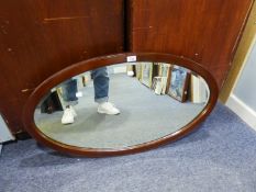 A LARGE OVAL BEVELLED EDGE WALL MIRROR, IN MAHOGANY FRAME, 3?1? HIGH, 2?3? WIDE OVERALL