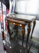 A NEST OF TWO MAHOGANY COFFEE TABLES WITH LEATHER INSET TOPS AND GLASS PROTECTORS