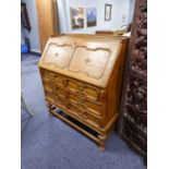 A JACOBEAN STYLE LIGHT OAK BUREAU WITH CENTILEVERED FITTED INTERIOR