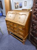 A JACOBEAN STYLE LIGHT OAK BUREAU WITH CENTILEVERED FITTED INTERIOR