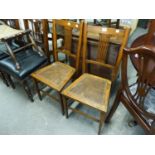 A PAIR OF OAK BEDROOM CHAIRS WITH PIERCED SPLAT BACK AND CANE SEATS (2)