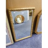 A RECTANGULAR BEVELLED EDGE WALL MIRROR, IN EMBOSSED GILT FRAME, 2?10? HIGH X 1?9? WIDE OVERALL