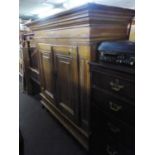 A CONTINENTAL PINE OVER-SIZED CUPBOARD HAVING TWO PANEL DOORS AND SHELVES TO THE INTERIOR, ALSO