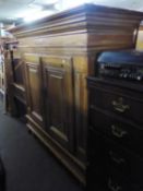 A CONTINENTAL PINE OVER-SIZED CUPBOARD HAVING TWO PANEL DOORS AND SHELVES TO THE INTERIOR, ALSO