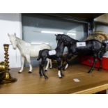 A ROYAL DOULTON GREY HORSE, A SIMILAR BROWN HORSE AND A ROYAL DOULTON FOAL (3)