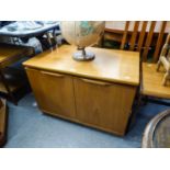 A TWO DOOR TEAK LOW CUPBOARD, HAVING TWO SLIDING SHELVES (56cm high x 78cm wide x 49cm deep)