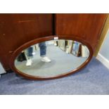 A LARGE OVAL BEVELLED EDGE WALL MIRROR, IN MAHOGANY FRAME, 3?1? HIGH, 2?3? WIDE OVERALL