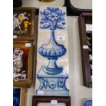 SUITE OF THREE ANTIQUE TILES, PAINTED BLUE ON WHITE TO FORM A PICTURE OF A PEDESTAL AND VASE OF