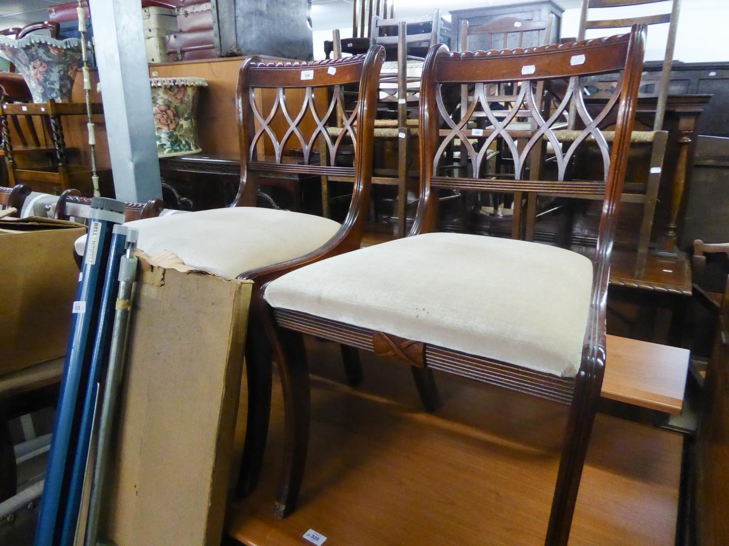 A SET OF FOUR REGENCY STYLE MAHOGANY DINING CHAIRS, WITH TRELLIS BACKS, TRAFALGAR SEAT, ON SABRE