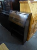 A SMALL OAK BUREAU WITH OPEN SHELVES BELOW