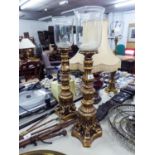 *PAIR OF ORNATE MOULDED COMPOSITION  AND GILT FLOOR STANDING CANDLE LAMPS WITH GLASS BUCKET SHAPED