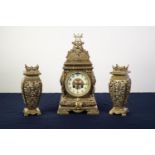 EARLY 20th CENTURY ORNATE AND CAST AND PIERCED BRASS THREE PIECE CLOCK GARNITURE, having spring