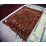 TURKOMAN STYLE MACHINE WOVEN BORDERED RUG with two rows of two large guls and part guls, on a