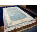 HEAVY QUALITY EMBOSSED WASHED CHINESE CARPET, the plain pale blue field having grey mon medallion,