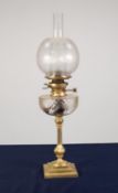 BRASS OIL TABLE LAMP, of slender, panelled baluster form with square, stepped base, cut glass