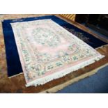 HEAVY QUALITY EMBOSSED WASHED CHINESE CARPET OF AUBUSSON DESIGN, on a plain pink field, large oval