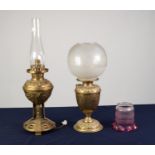 TWO BRASS OIL TABLE LAMPS, one with embossed foot, engraved reservoir and frosted glass shade, 17 ½?