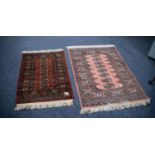 PAKISTAN 'BOKHARA' SMALL RUG with a single row of seven guls, on a wine red field, repeat pattern