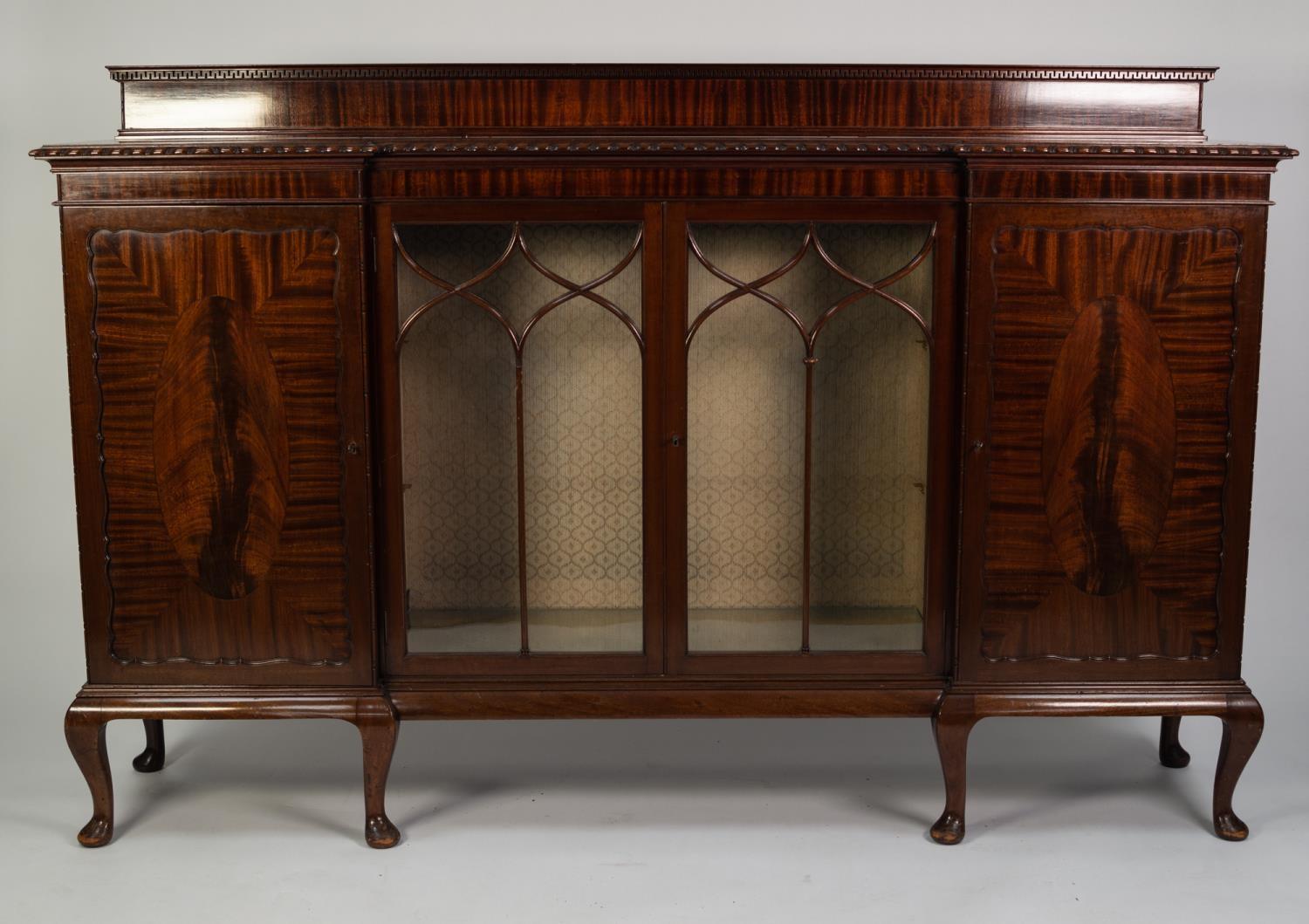 EARLY TWENTIETH CENTURY FIGURED MAHOGANY INVERTED BREAKFRONT DISPLAY CABINET, the shaped top with