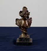 A SMALL TWENTIETH CENTURY PATINATED METAL BUST OF A FEMALE in Art Nouveau taste, on stepped marble