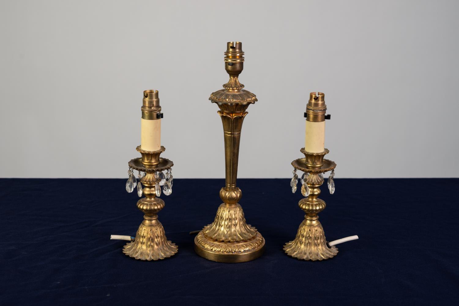 THREE SIMILAR, MODERN CAST BRASS ELECTRIC TABLE LAMP BASES, one of tapering form with leaf cast