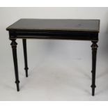 NINETEENTH CENTURY EBONISED AND GILT METAL MOUNTED FOLD-OVER CARD TABLE. The oblong swivel top