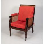 EARLY NINETEENTH CENTURY MAHOGANY BERGERE EASY ARMCHAIR, the square, moulded show wood frame with