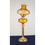 BRASS CORINTHIAN COLUMN PATTERN OIL TABLE LAMP, with circular, stepped base, moulded amber glass