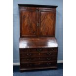 GEORGE III FIGURED MAHOGANY BUREAU BOOKCASE, the moulded cornice above a pair of flame cut, panelled