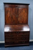 GEORGE III FIGURED MAHOGANY BUREAU BOOKCASE, the moulded cornice above a pair of flame cut, panelled
