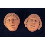 PAIR OF HEAVY TERRA COTTA CLASSICAL MALE AND FEMALE WALL MASKS, 9 1/2in (24cm) high, with raised