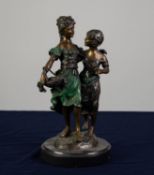 A TWENTIETH CENTURY PATINATED AND COLD PAINTED BRONZE GROUP  of two young ladies, one carrying a