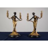 A PAIR OF TWENTIETH CENTURY POLISHED AND DARK LACQUERED BRASS TWIN BRANCH FIGURAL CANDELABRA on