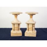 PAIR OF VARIEGATED CREAM ONYX CLOCK SIDE GARNITURES IN TEH FORM OF PEDESTAL DISHES OR VIDE-POCHE,