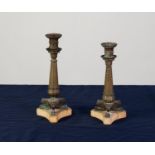 TWO VERY SIMILAR REGENCY BRONZE CLASSICAL STYLE TABLE CANDLESTICKS of sectional form, having tapered