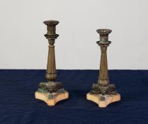 TWO VERY SIMILAR REGENCY BRONZE CLASSICAL STYLE TABLE CANDLESTICKS of sectional form, having tapered