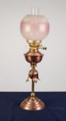 STYLISH COPPER AND BRASS OIL TABLE LAMP, of slender column form with leaf pattern collar, moulded