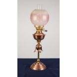 STYLISH COPPER AND BRASS OIL TABLE LAMP, of slender column form with leaf pattern collar, moulded