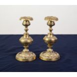 PAIR OF 19th CENTURY EMBOSSED AND CAST BRASS CANDLESTICKS, having floral or foliate decorative