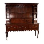 LATE EIGHTEENTH CENTURY OAK DRESSER, the enclosed plate rack with moulded cornice and fret cut apron