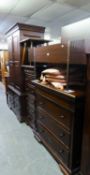 CONTINENTAL MAHOGANY BEDROOM SUITE COMPRISING A GARDEROBE WITH FOUR SHORT DRAWERS BELOW; A TALLBOY
