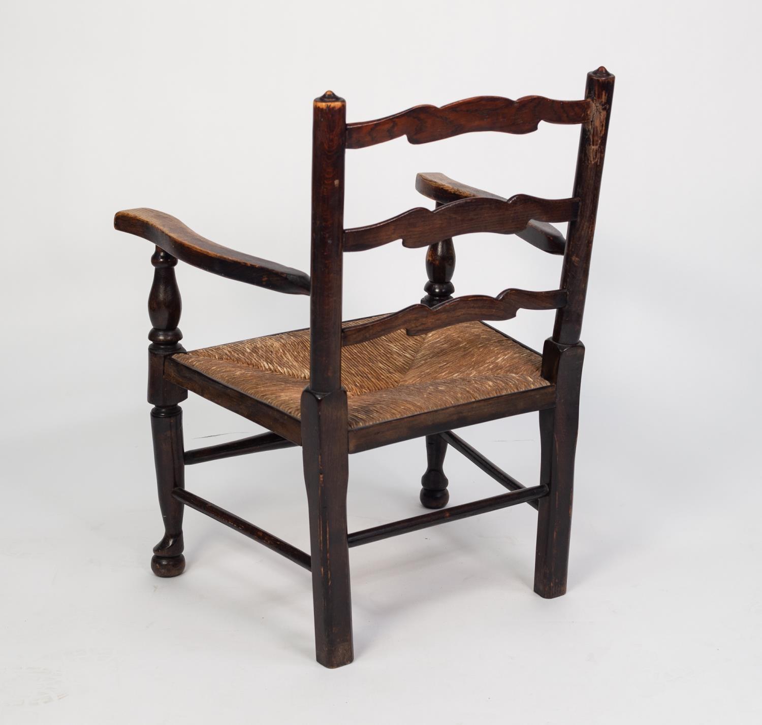 NINETEENTH CENTURY ELM LADDER BACK NURSING OPEN ARMCHAIR WITH LOW RUSH SEAT, enclosed by flat, - Image 2 of 2