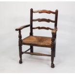 NINETEENTH CENTURY ELM LADDER BACK NURSING OPEN ARMCHAIR WITH LOW RUSH SEAT, enclosed by flat,