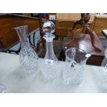 A CUT GLASS SKITTLE SHAPED WINE DECANTER AND STOPPER; A CUT GLASS CARAFE AND A CUT GLASS WATER