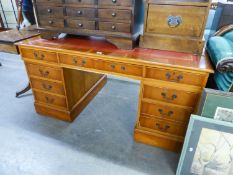 A GOOD QUALITY REPRODUCTION YEW-WOOD TWIN PEDESTAL DESK, WITH RED LEATHER INSET TOP WITH SINGLE