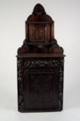 LATE NINETEENTH/ EARLY TWENTIETH CENTURY CONTINENTAL CARVED DARK OAK FLOOR STANDING CORNER CUPBOARD,