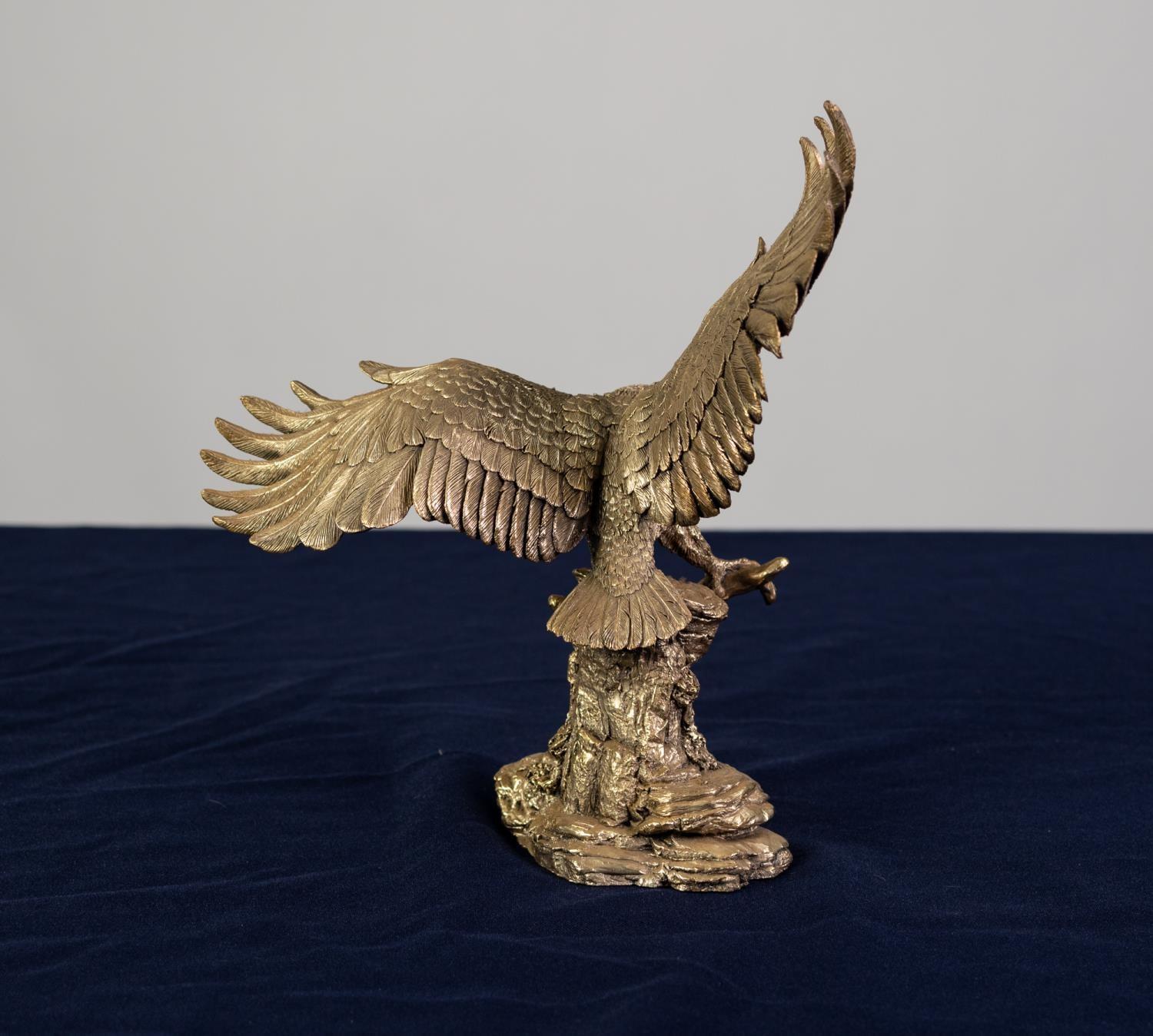 A MODERN COLD CAST RESIN FILLED GILT FINISH 'STERLING SILVER' MODEL OF AN EAGLE,  perched on a - Image 2 of 2